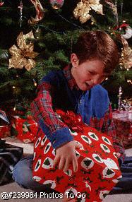 Boy w/present near Christmas tree